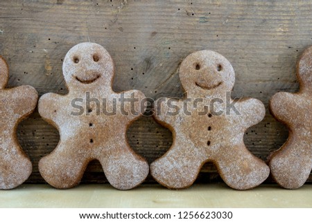 Tasty gingerbreads on a wooden table in the kitchen. Small cookies for Christmas. Light background.
