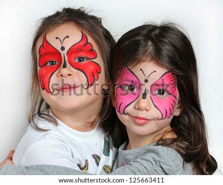 Two girls with face painting of a butterfly. Royalty-Free Stock Photo #125663411