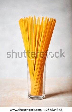Raw uncooked italian  pasta in bowl. Selective focus 