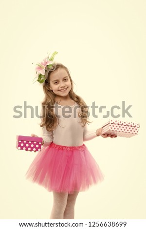 Childhood and happiness. Holiday celebration and mothers day. Christmas and birthday. Child or happy kid with present pack isolated on white background. Small girl with gift box with red bow