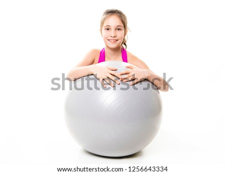 A Kid girl having fun with gymnastic ball isolated