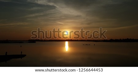 Lake with boat, sunset, river where fishermen are fishing, lake view, river view, sunset view.