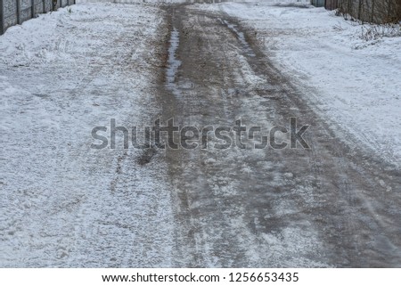 part of the winter road with gray and white dirty snow