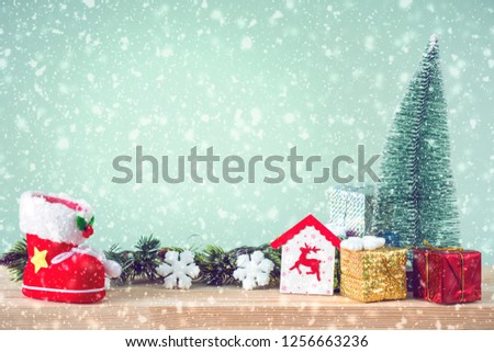 Christmas background. Christmas tree and ornaments lie on a wooden table snowy weather. Space for text. It's snowing. Merry Christmas. New Year's background. Toned image.