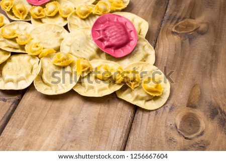 Ravioli like christmas tree on wooden background. Holidays in Italy. The decor of the food. Free space for text