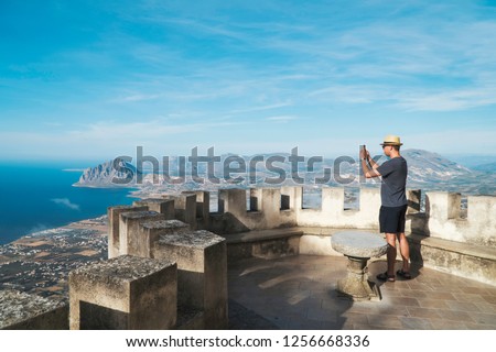 Turist taking picture of landscape in old castle. 