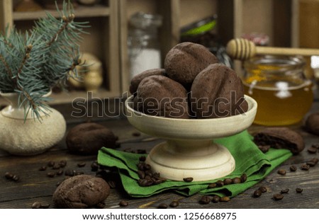 Chocolate cookies in a wooden vase on a wooden background