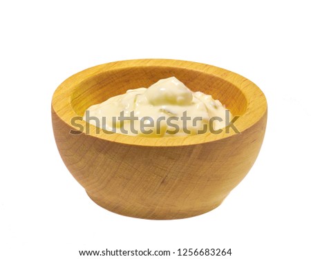 Wooden bowl of sour cream sauce with herbs  isolated on white background