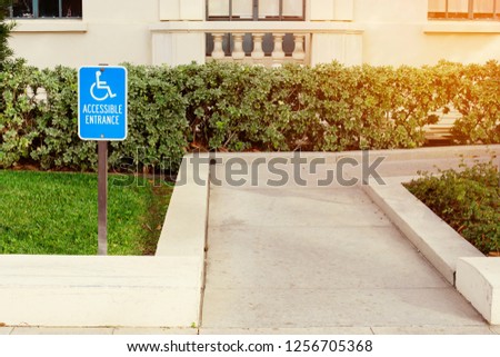 View of a disabled person walk way with a blue handicap sign