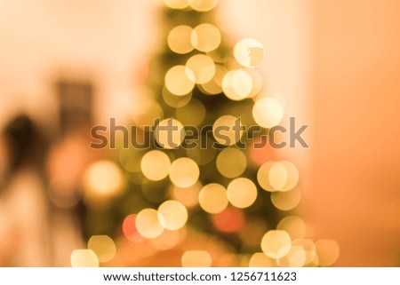 Defocused Christmas Orange bokeh white color lights blur city background in party night light decoration in soft for greeting card backdrop with glitter sparkle blurred circles.