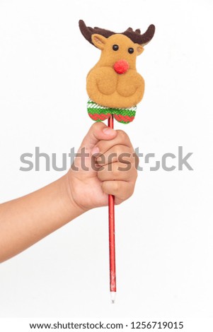 Hand hold red pen with teddy deer head, Isolated on white background.
