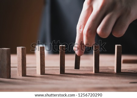 man hand pick one from many wooden blocks.business concept of choosing the right amongst other ones,Planning,risk and strategy,businessman gambling investment