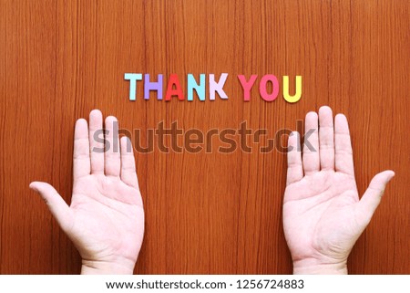 thank you text wood and men's hand over wooden table