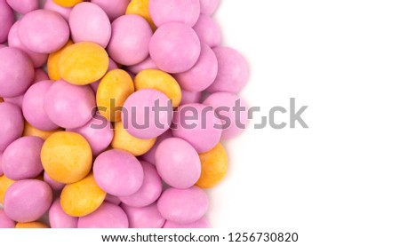 A Pile of Candy Coated Chocolate Gems on a White Background