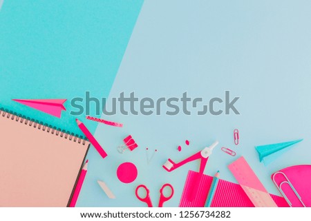 Pink stationery on a blue pastel background. Creative, concept flat lay.