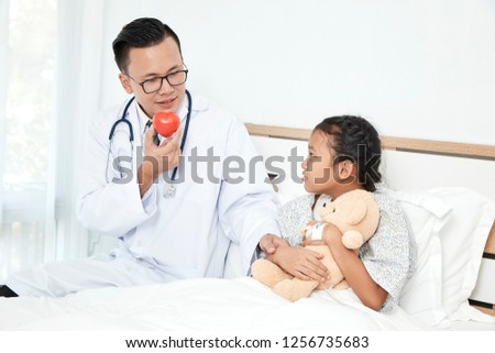 Care, Doctor with stethoscope holding red heart and kid girl in the patient room, Healthcare and medicine concept - Cancer girl awareness