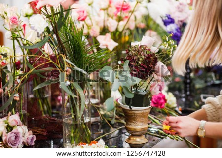 Flowers composition. Abstract background of flowers. Female florist making beautiful bouquet at flower shop. Close-up.