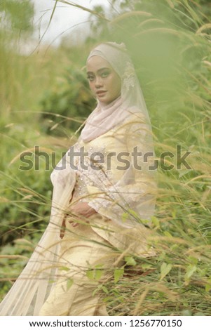 beautiful Asian women wearing yellow hijab and wedding dress fashion