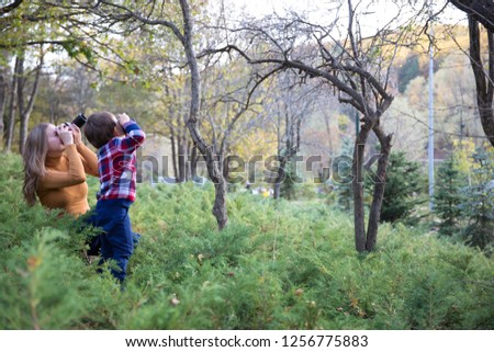 Mother taking Photo with her son in nature