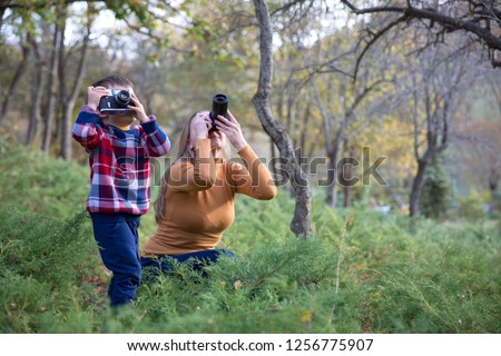 Mother taking Photo with her son in nature
