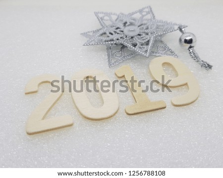 2019 wooden figures with star shape silver ornament isolated on white background.Copy space.New year greeting card template ,Vintage concept.