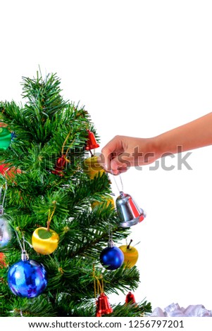 hand of asian child holding little bell for decoration Christmas Tree and gift boxes. Christmas or happy newyear time isolated on white background with clipping path
