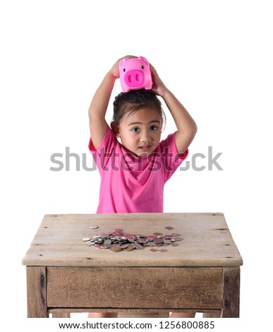 Cute asian little girl have fun with piggy bank and coins isolated on white background with clipping path. Education Savings concepts