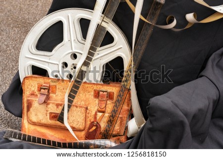 Old Film stock, strip. Old Film reel, bobbin, spool against a dark background.  Concept Cinema, filming of movies. Hollywood