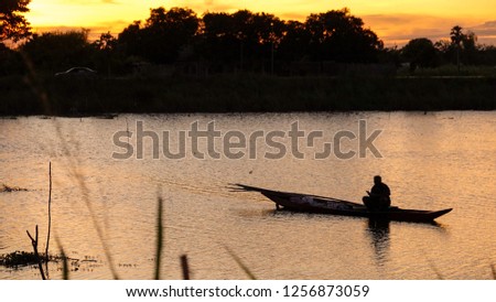 Silhouette of the man in a boat.