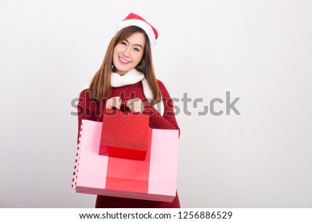 Portrait of happy asian women action shot of relax shopping with shopping bag on Christmas and New years day for Celebration on white background space for text. Christmas and New year Concept
