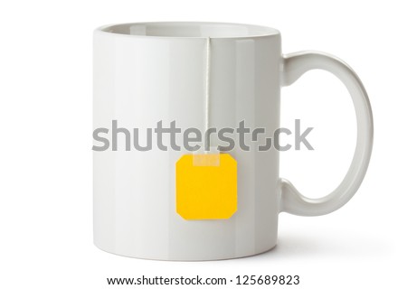 White ceramic mug with teabag label. Isolated on a white. Royalty-Free Stock Photo #125689823