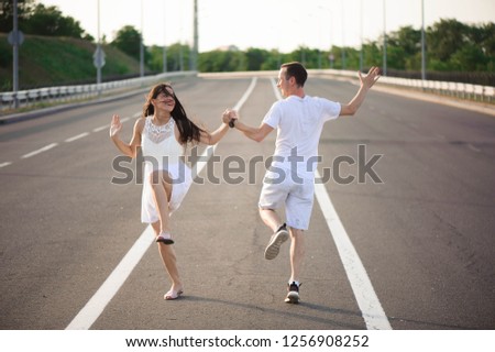 Couple in love - Beginning of a Love Story. A man and a girl dancing on the road.