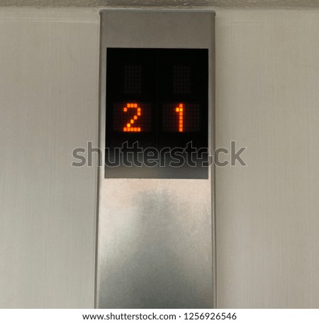 Elevator or lift digital display board with floor numbers 2 and 1 on black screen