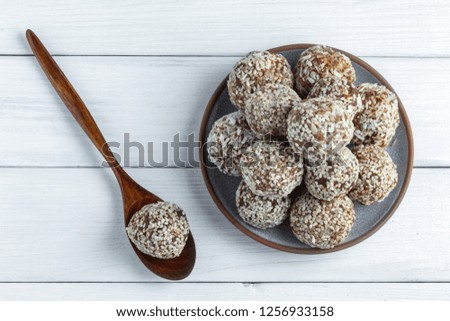 Close up of No Bake Energy Balls on white background with wooden spoon. Top view. Soft focus Royalty-Free Stock Photo #1256933158