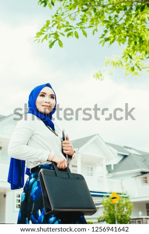 Professional young muslim business woman working on work plan over the city background
