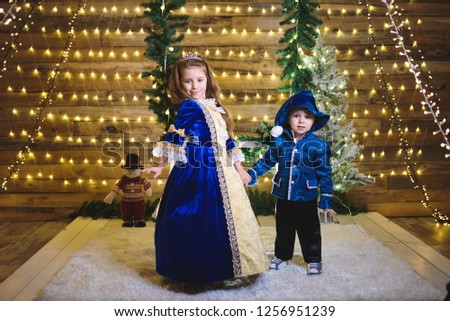 boy and girl holding hands in christmas lights