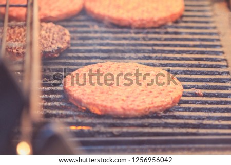 Close-up burger cutlet fried on a grill. Street fast food