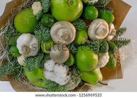 Original winter bouquet made of green fruits, vegetables and mushrooms. Detailed picture