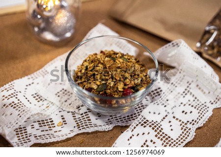 Homemade granola in glass jar on wooden table. healthy breakfast