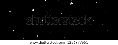 falling snowflakes in front of black background