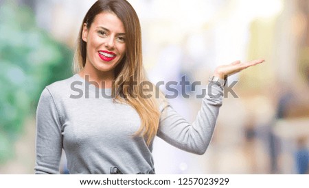 Young beautiful worker business woman over isolated background smiling cheerful presenting and pointing with palm of hand looking at the camera.
