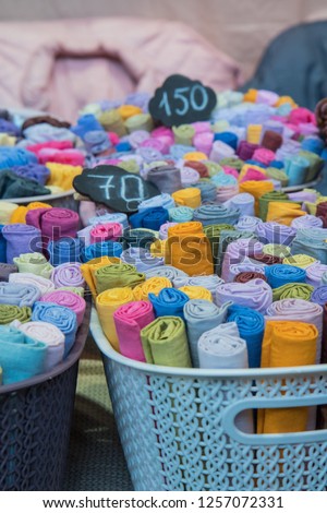 Traditional fabric store with stacks of colorful textiles, fabric rolls at market stall - textile industry background with blurred. Fabric Store, Traditional