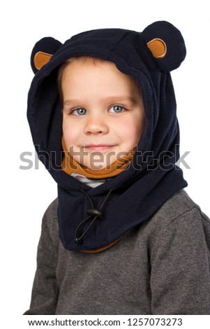 Cheerful little boy in a carnival hat in the form of a blue bear