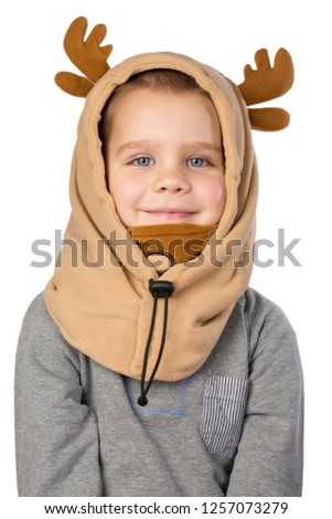 Cheerful little boy in a carnival hat with horns