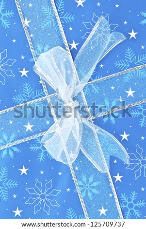 Cropped close-up image of a blue Christmas present.