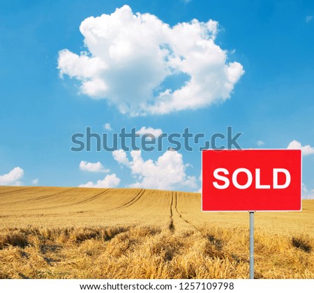 Wheat field with SOLD sign