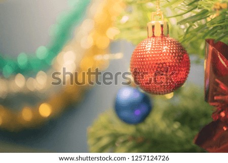 Closeup bauble hanging from a decorated Christmas tree on blurred background with copy space - Image