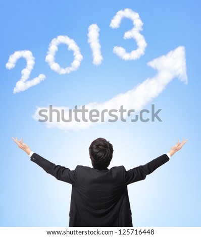 back view of Business man hug happy new year 2013 (white cloud and blue sky on sunny day) with blue sky background, asian model