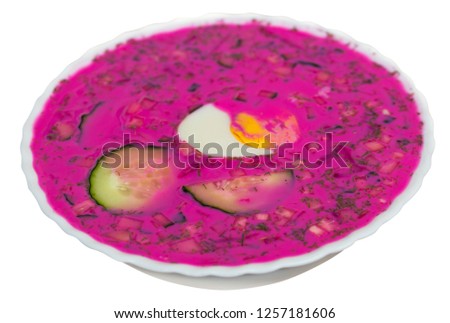 Traditional Belarusian cold beetroot soup with cucumber, yogurt and eggs. Isolated over white background

