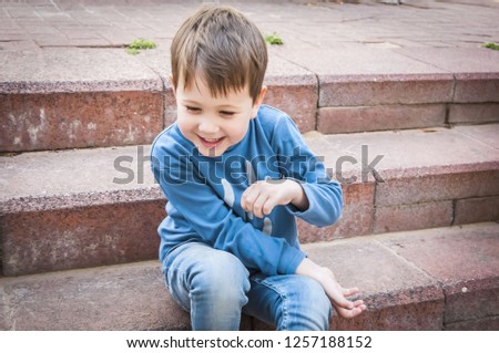 Cute Caucasian toddler boy laughing hilariously portrait.